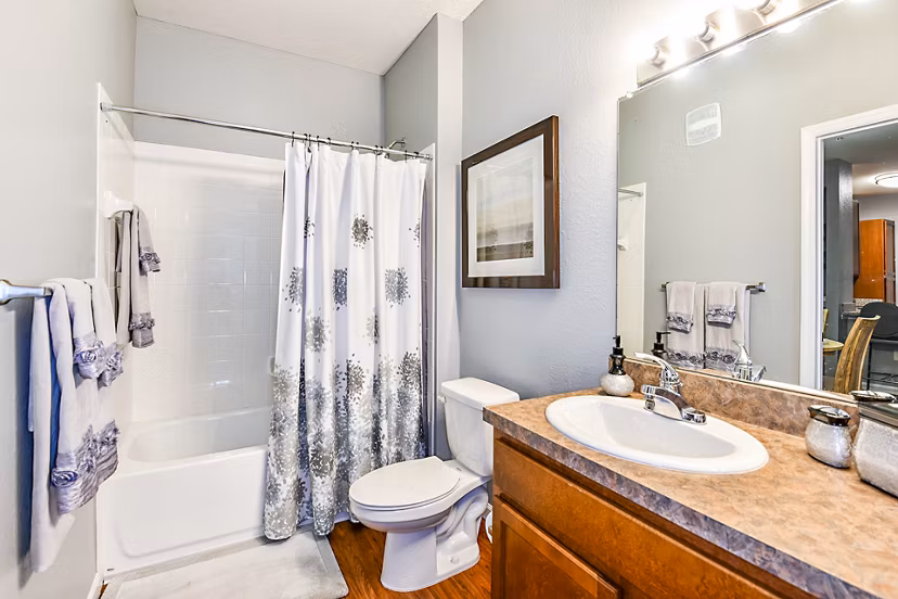 Modern bathroom with sleek fixtures and tile flooring at Windermere Cay Apartments, offering luxury living in a stylish setting