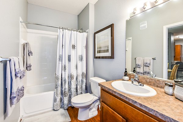 Modern bathroom with sleek fixtures and tile flooring at Windermere Cay Apartments, offering luxury living in a stylish setting