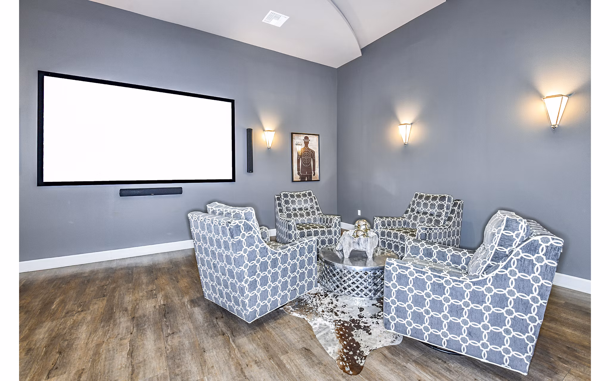 Clubhouse theater with plush seating and large screen at Windermere Cay Apartments, luxury living by Greystar