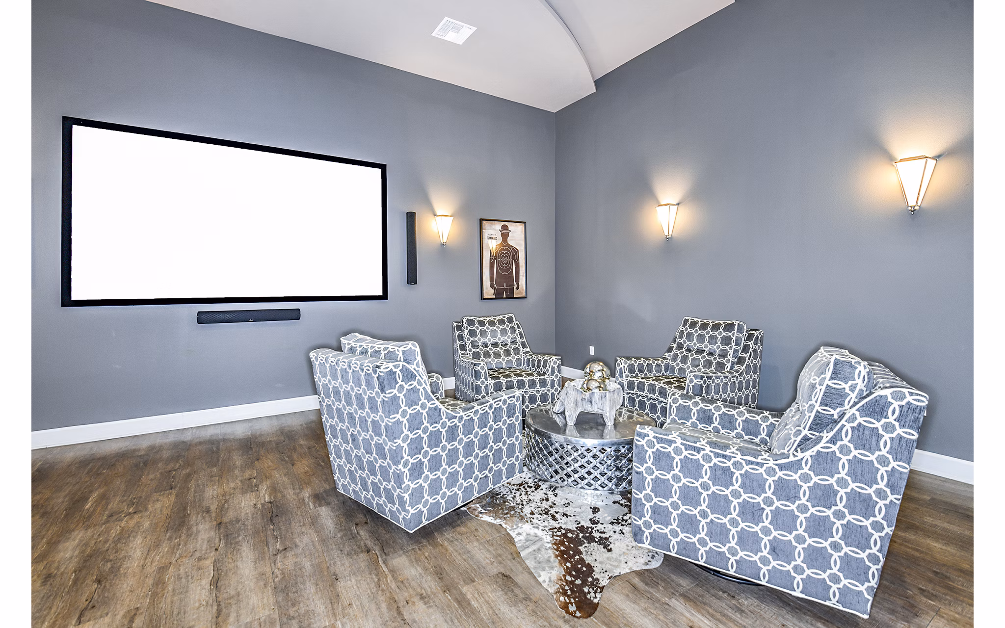 Clubhouse theater with plush seating and large screen at Windermere Cay Apartments, luxury living by Greystar