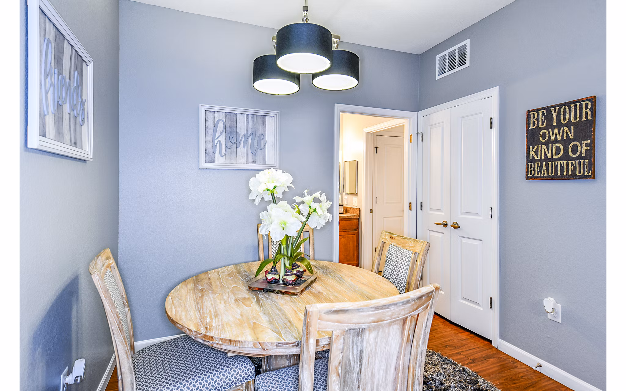 Dining room with modern lighting and elegant furnishings at Windermere Cay Apartments