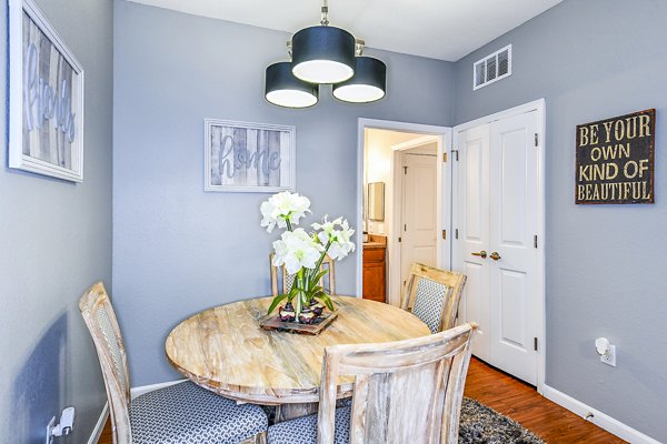Dining room with modern lighting and elegant furnishings at Windermere Cay Apartments