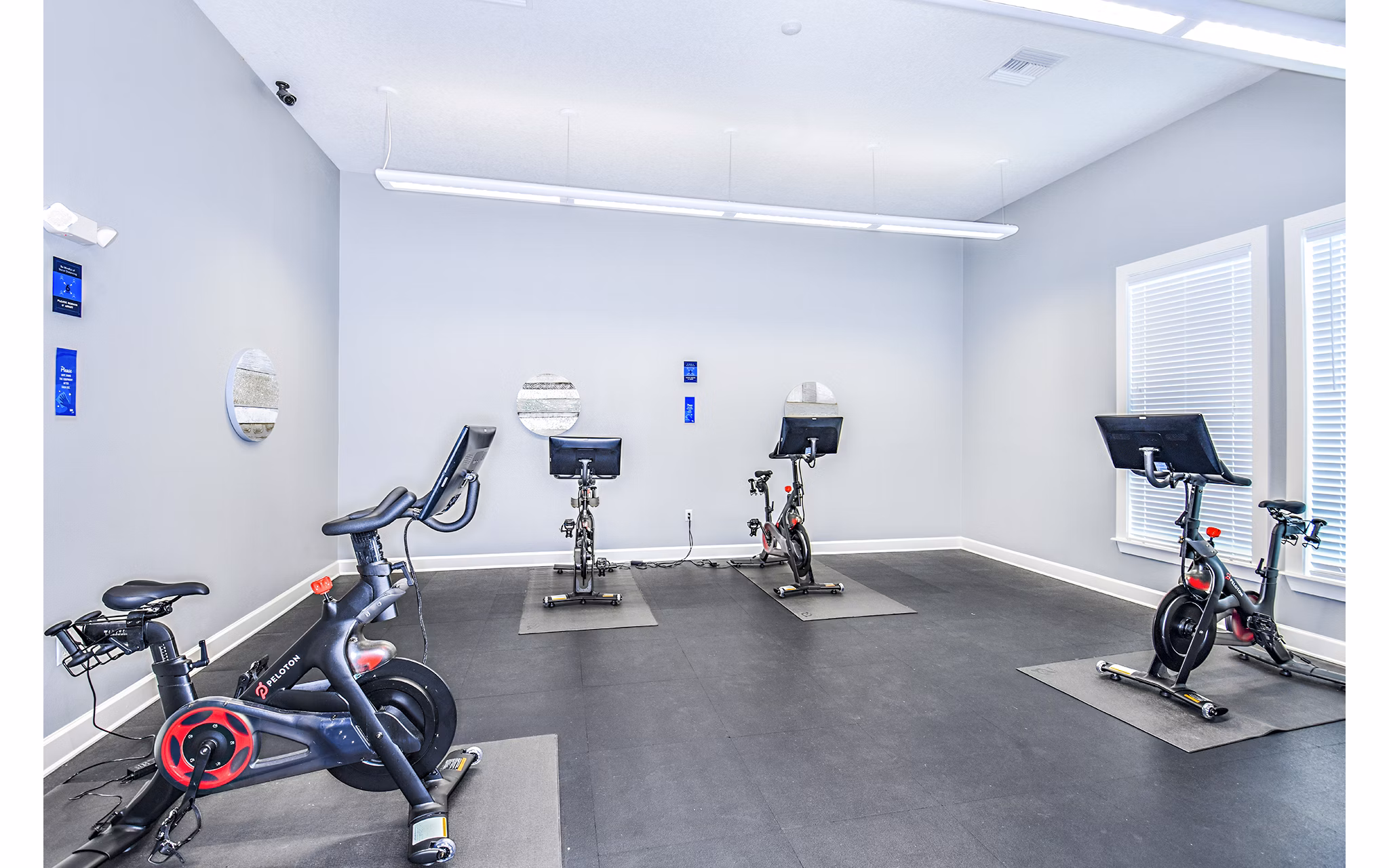 State-of-the-art spin studio with bikes and mirrors at Windermere Cay Apartments, offering luxury amenities and fitness classes