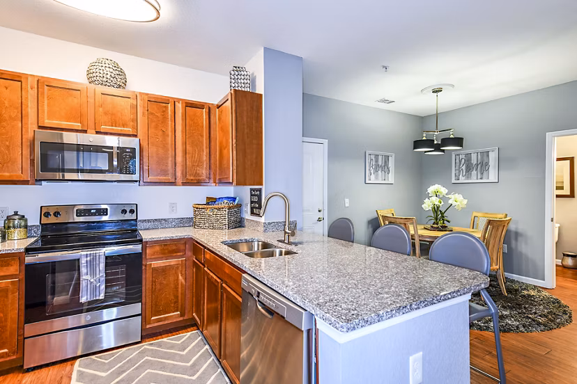 Modern kitchen with stainless steel appliances at Windermere Cay Apartments