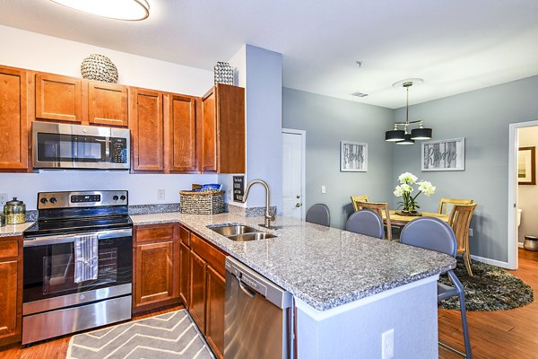 Modern kitchen with stainless steel appliances at Windermere Cay Apartments