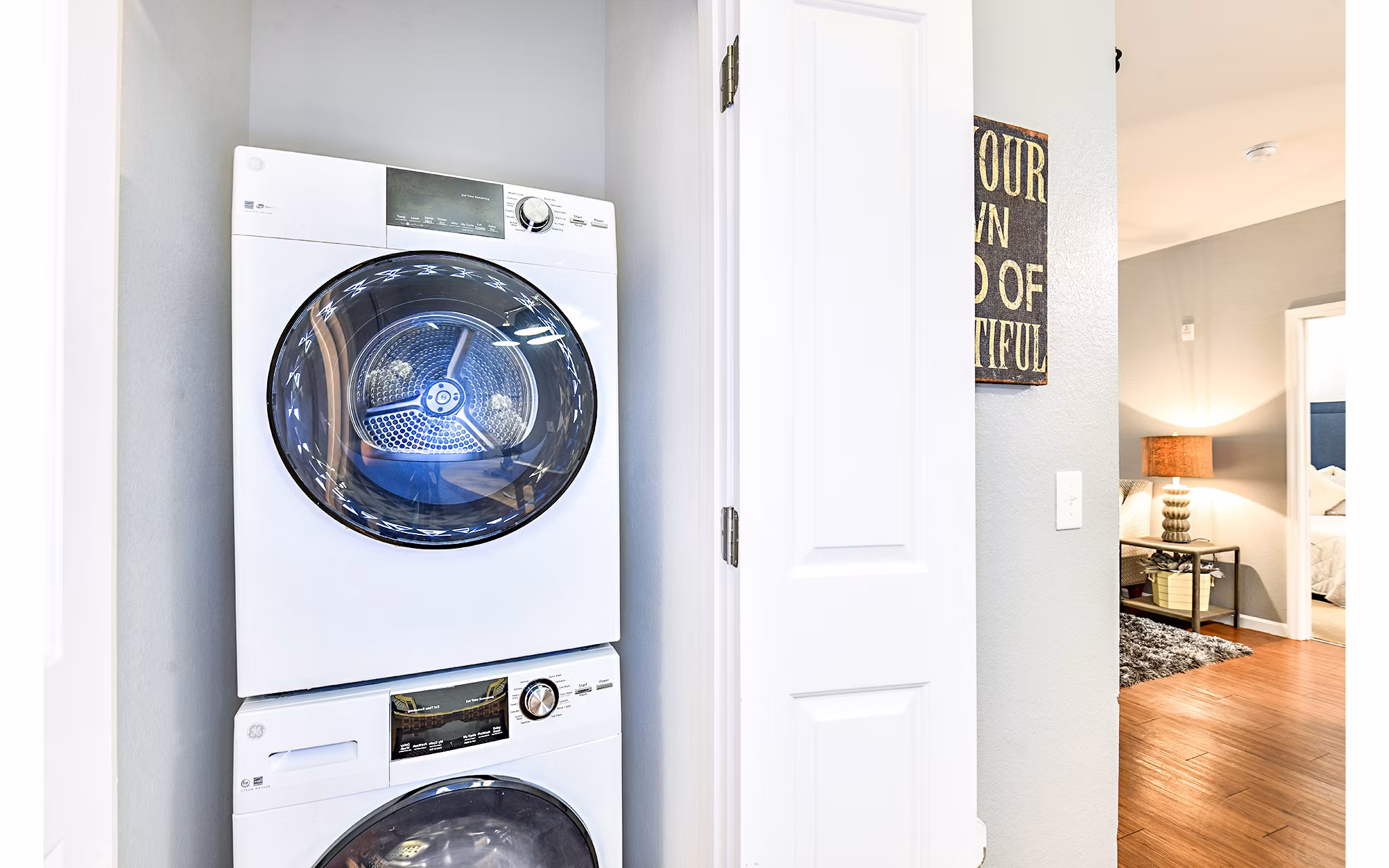 Laundry room with modern machines and ample folding area at Windermere Cay Apartments