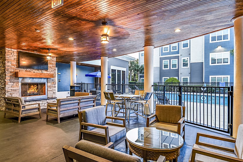 Fire pit and patio area at Windermere Cay Apartments offering cozy outdoor seating for socializing and relaxation