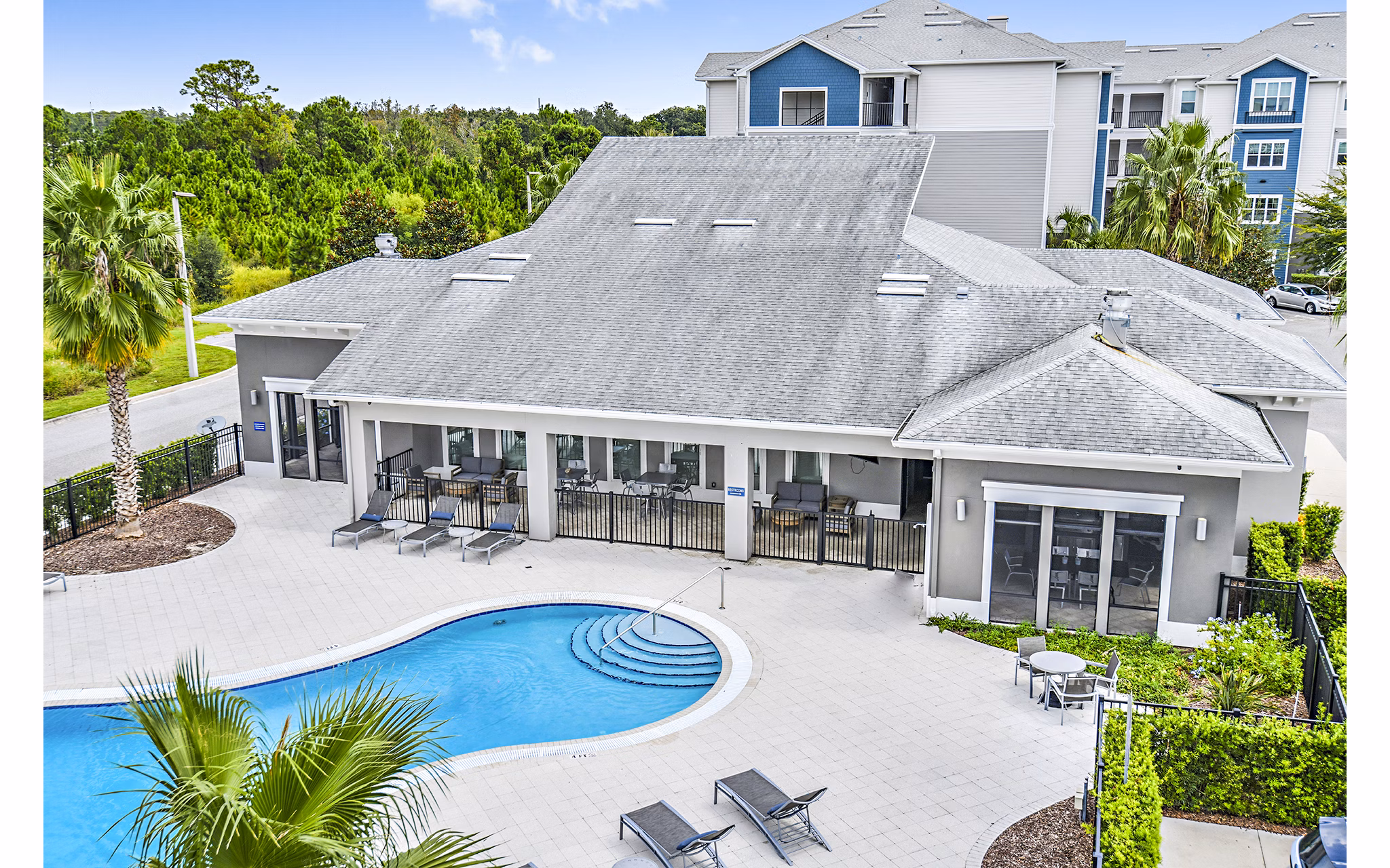 Resort-style pool with palm trees at Windermere Cay Apartments