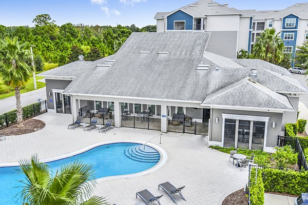 Resort-style pool with palm trees at Windermere Cay Apartments