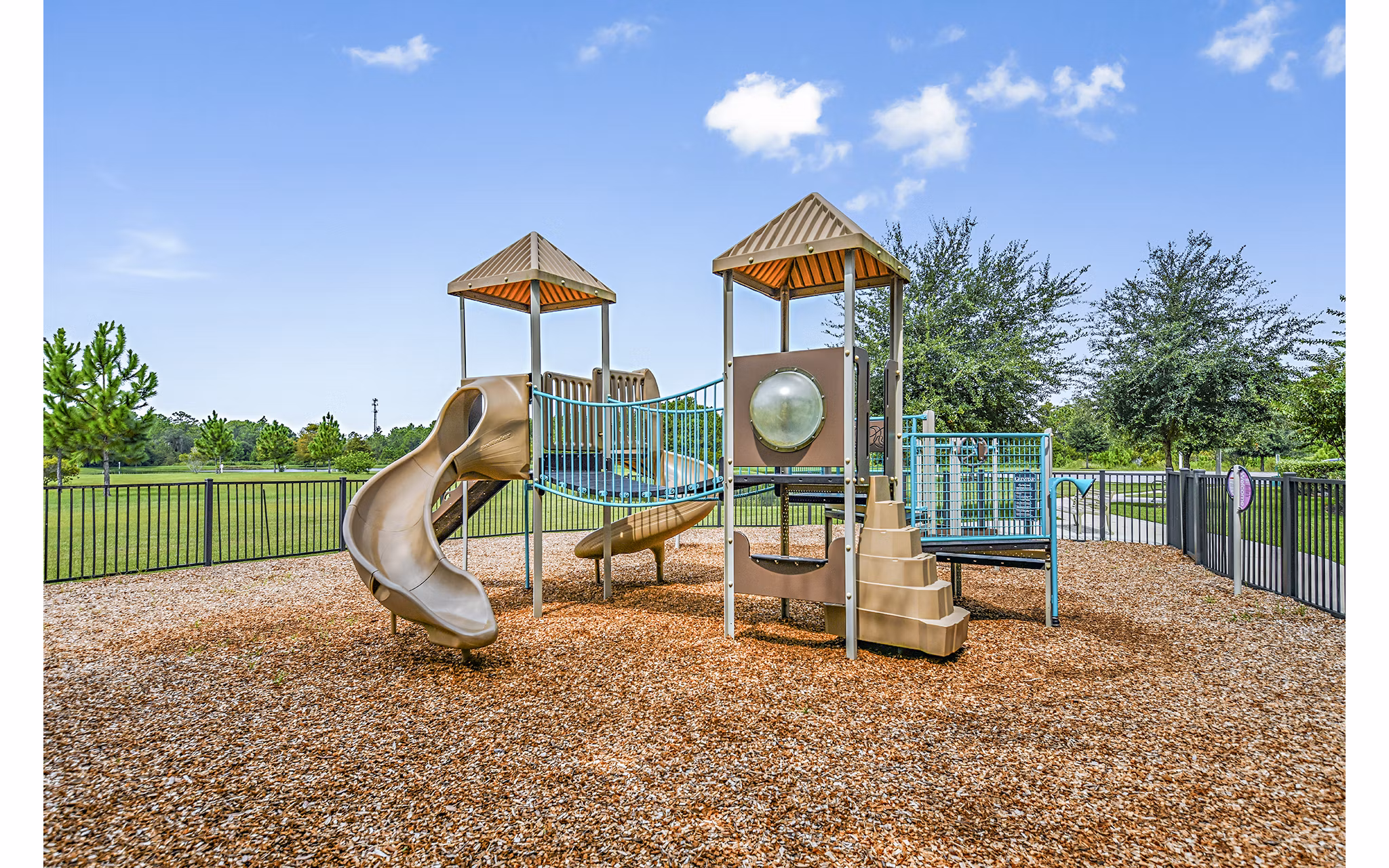 Children's playground with colorful equipment at Windermere Cay Apartments, a Greystar luxury community