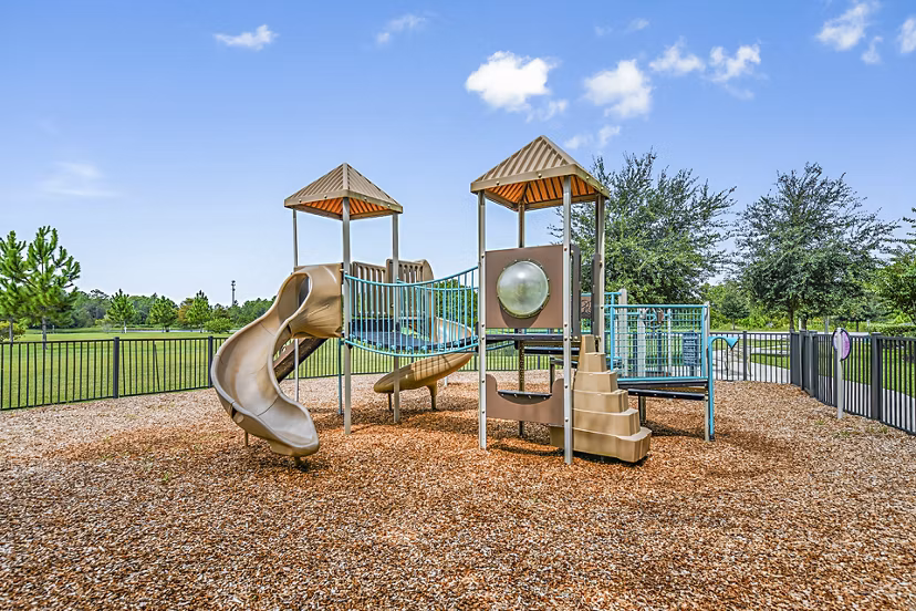 Children's playground with colorful equipment at Windermere Cay Apartments, a Greystar luxury community