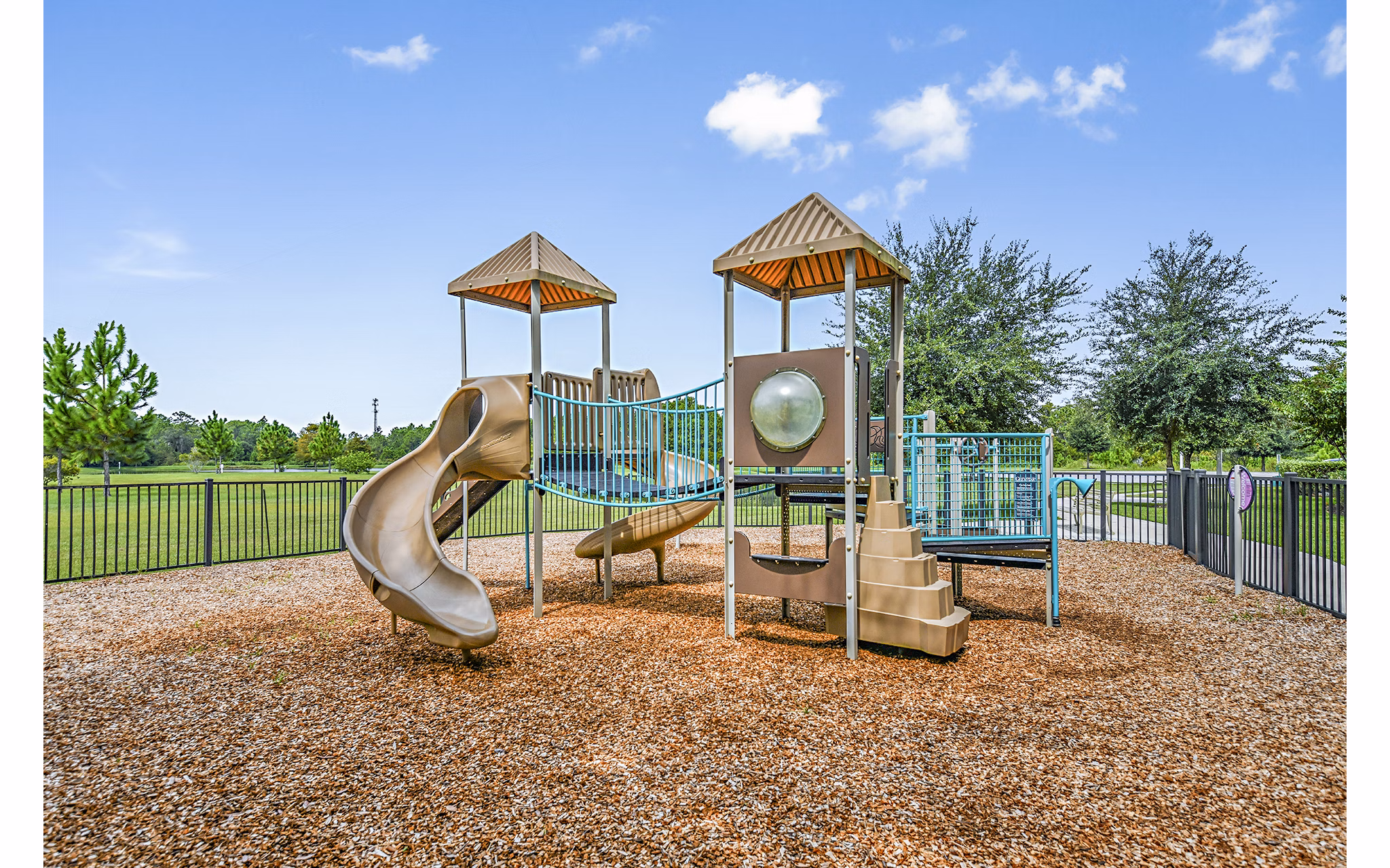 Children's playground with colorful equipment at Windermere Cay Apartments, a Greystar luxury community