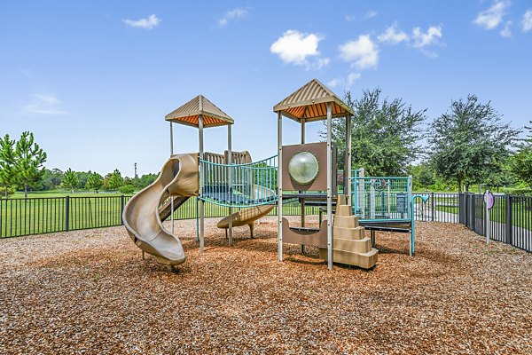 Children's playground with colorful equipment at Windermere Cay Apartments, a Greystar luxury community