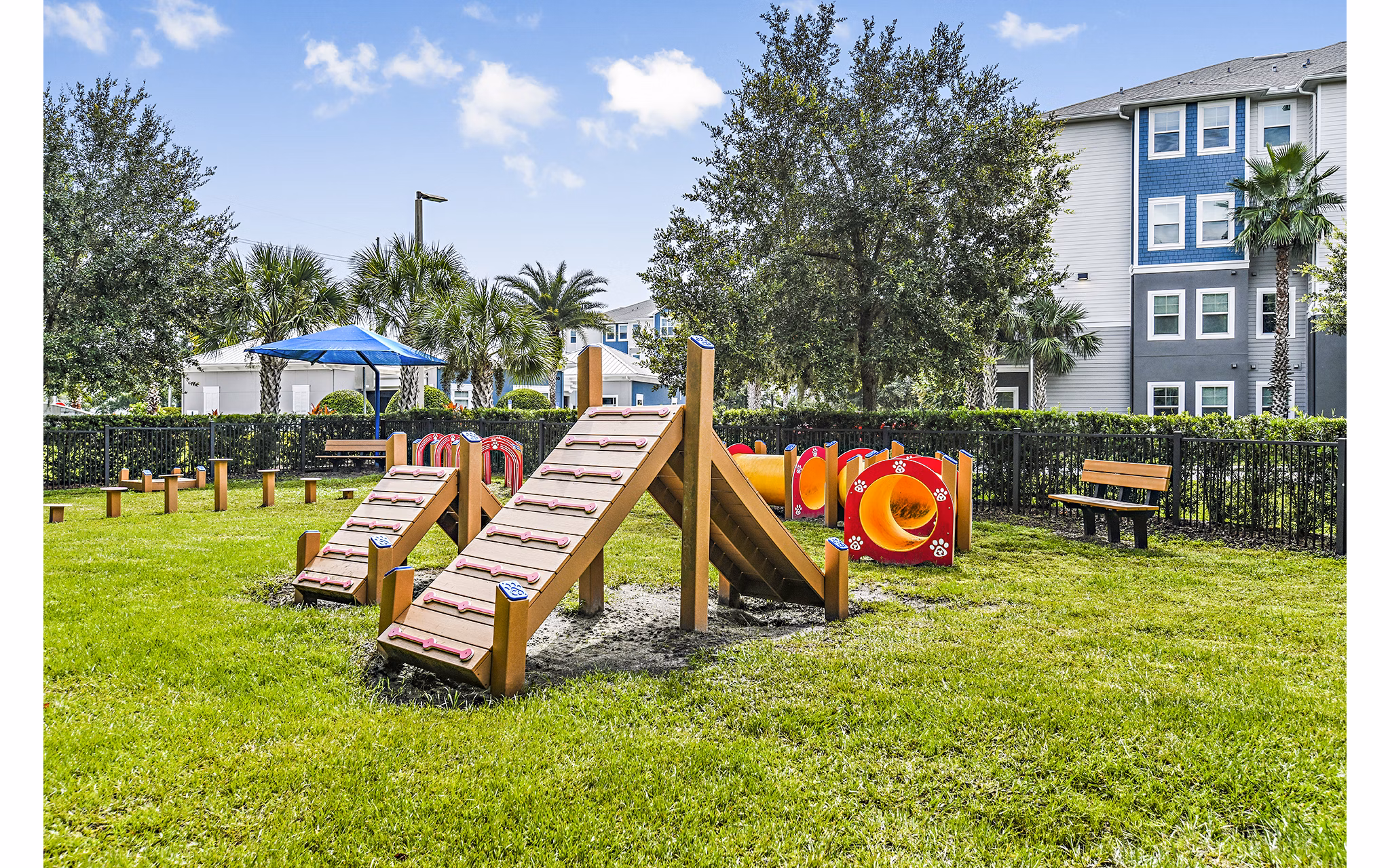 Expansive dog park with lush greenery at Windermere Cay Apartments, ideal for pet-friendly community living