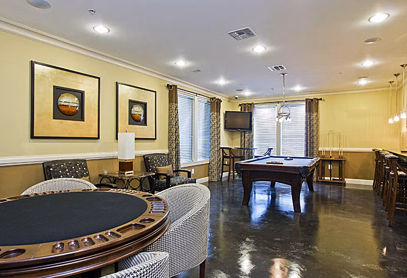 Aqua at Millenia Apartments: Elegant clubhouse with modern seating and ambient lighting in a luxury Orlando community