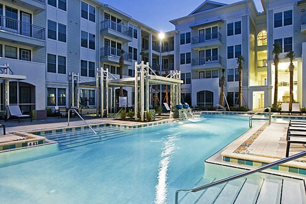 Resort-style pool at Aqua at Millenia Apartments offering luxurious relaxation and sunbathing area