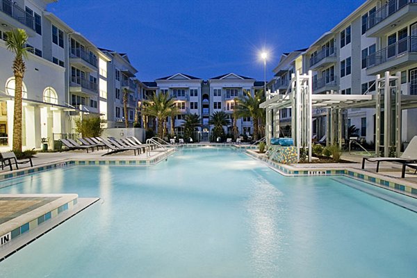 Resort-style pool with sun loungers at Aqua at Millenia Apartments, luxury living oasis