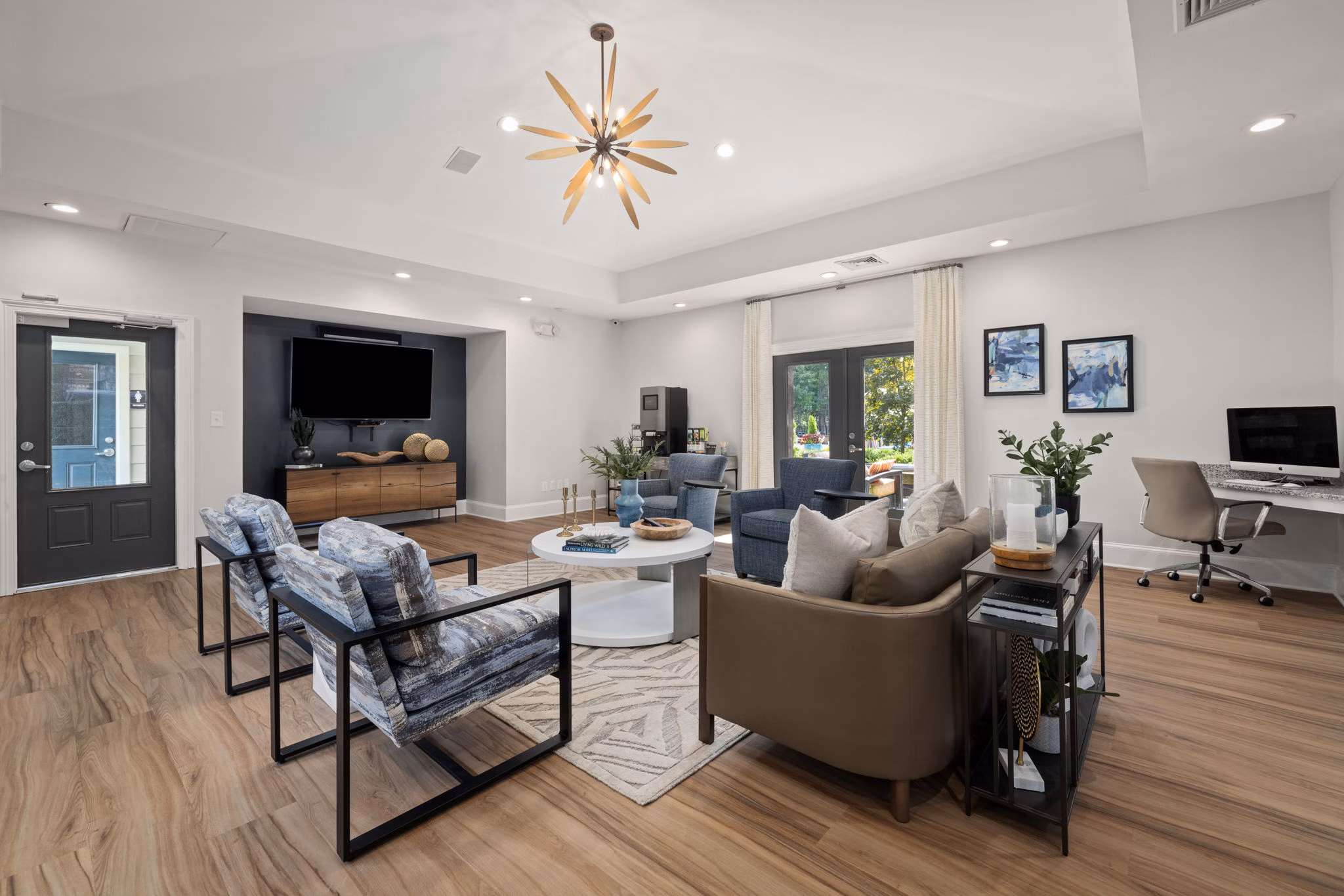 Modern clubhouse featuring cozy seating and entertainment area at The Morgan at Chapel Hill Apartments