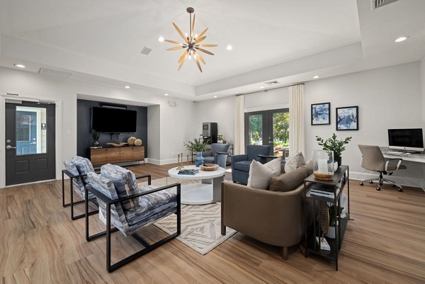 Modern clubhouse featuring cozy seating and entertainment area at The Morgan at Chapel Hill Apartments