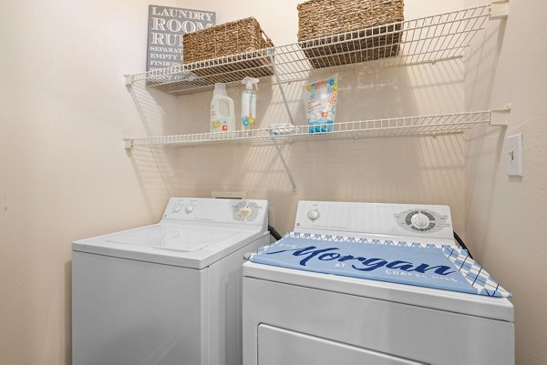 Laundry room featuring modern appliances at The Morgan at Chapel Hill Apartments