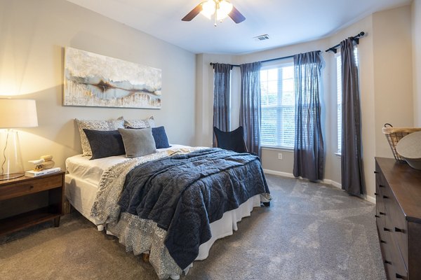 Spacious bedroom with modern decor at Wakefield Glen Apartments in North Carolina