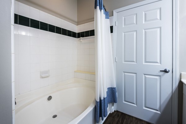 Luxurious bathroom with modern fixtures at Wakefield Glen Apartments, showcasing granite countertops and contemporary design