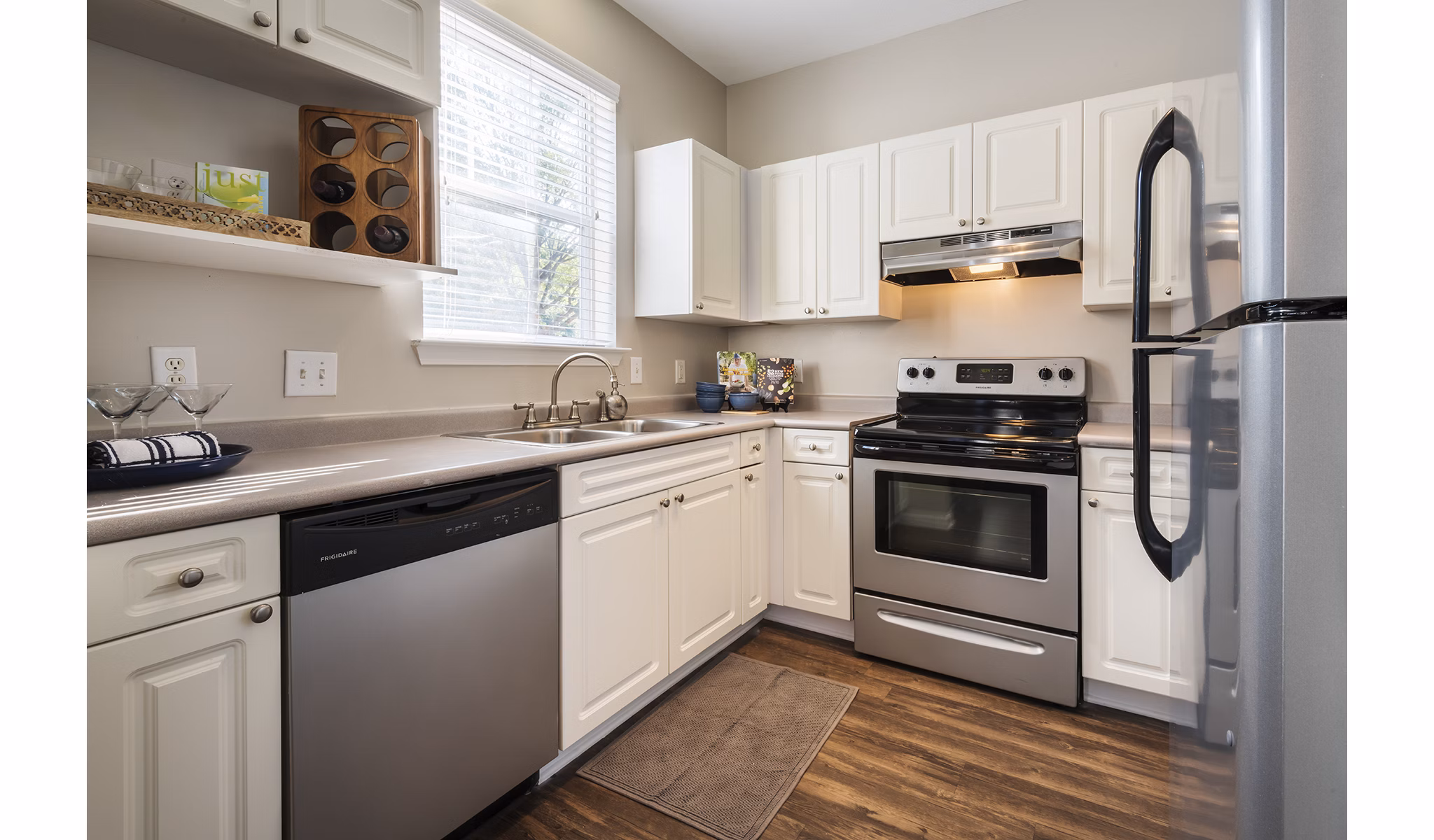 Modern kitchen featuring stainless steel appliances and granite countertops in Wakefield Glen Apartments