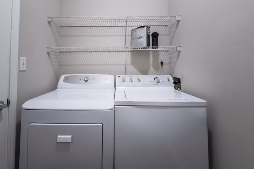Laundry room with modern appliances in Wakefield Glen Apartments offering convenience in luxury living