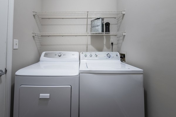 Laundry room with modern appliances in Wakefield Glen Apartments offering convenience in luxury living