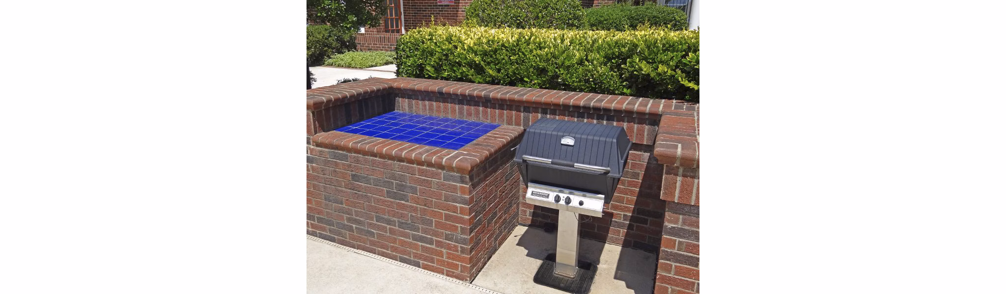 Modern outdoor grill area at Wakefield Glen Apartments offering luxury amenities for social gatherings in a stylish setting