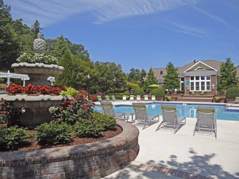 Tranquil outdoor pool at Wakefield Glen Apartments offering relaxation in a luxurious Greystar community setting