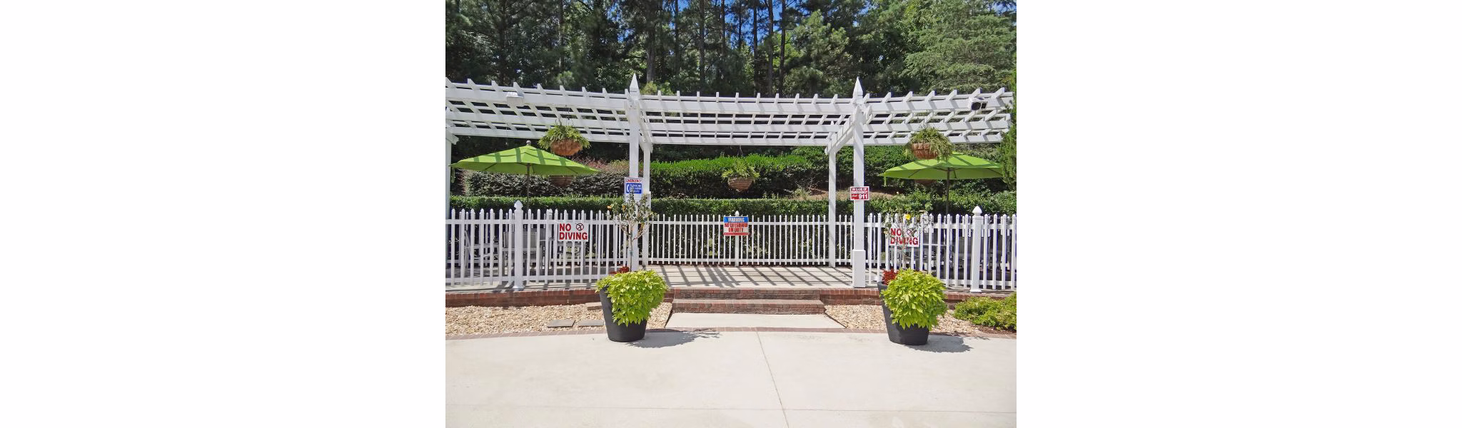 Relaxing outdoor patio at Wakefield Glen Apartments with cozy seating and lush greenery, perfect for enjoying sunny days and cool evenings