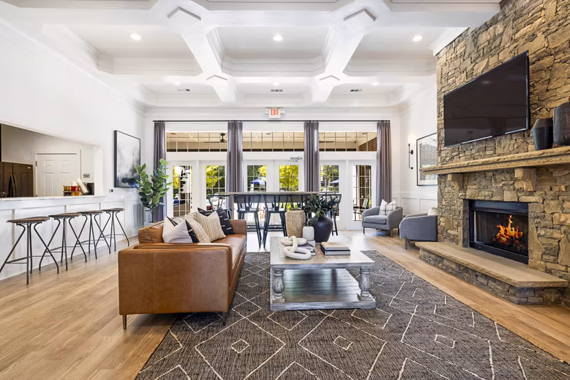 Tradition at Stonewater Apartments: Elegant clubhouse featuring modern design and seating areas