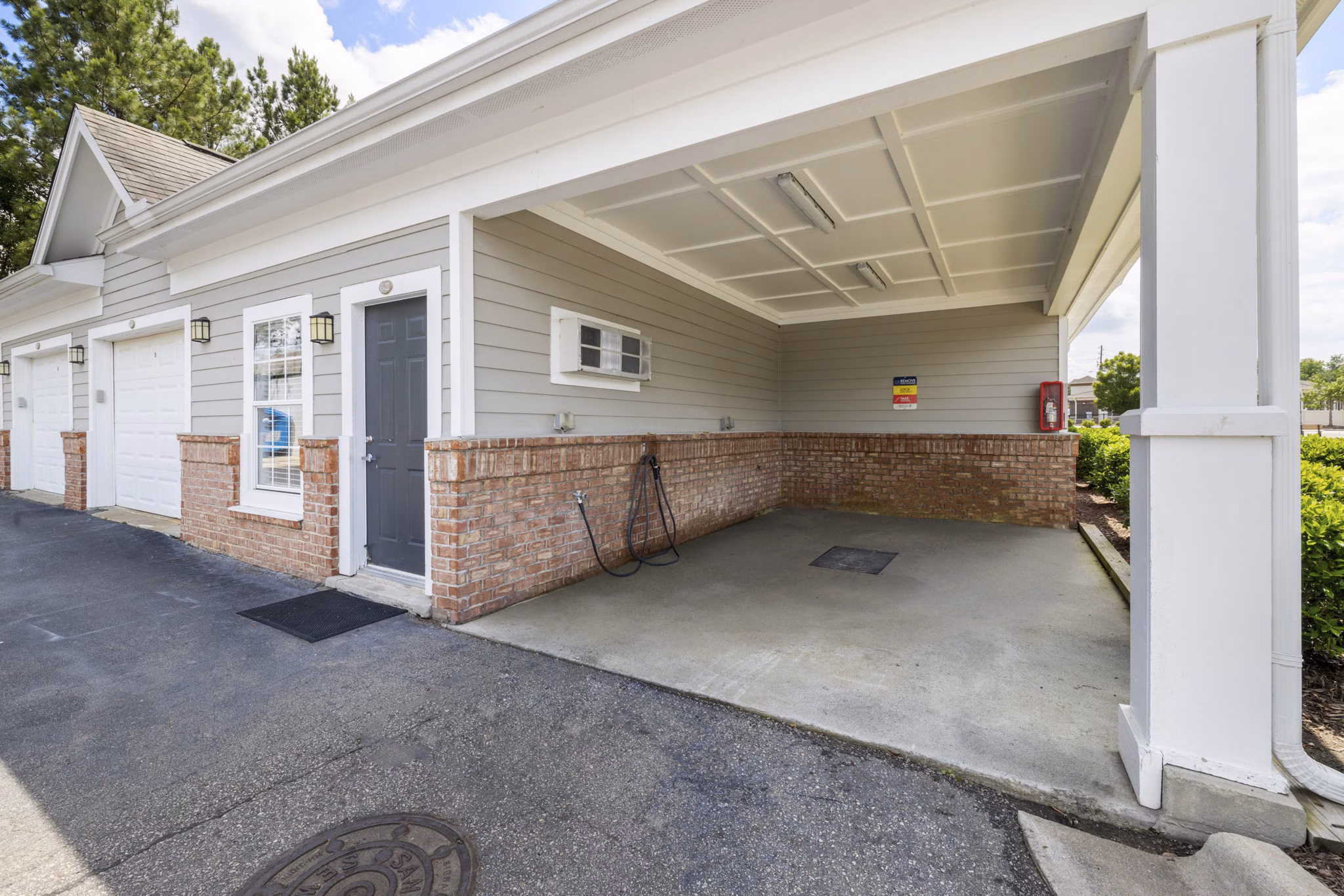 Car care station at Tradition at Stonewater Apartments offering vehicle maintenance amenities