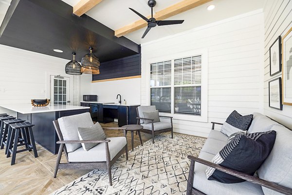 Charming outdoor patio with modern furniture at Tradition at Stonewater Apartments, perfect for relaxation and social gatherings