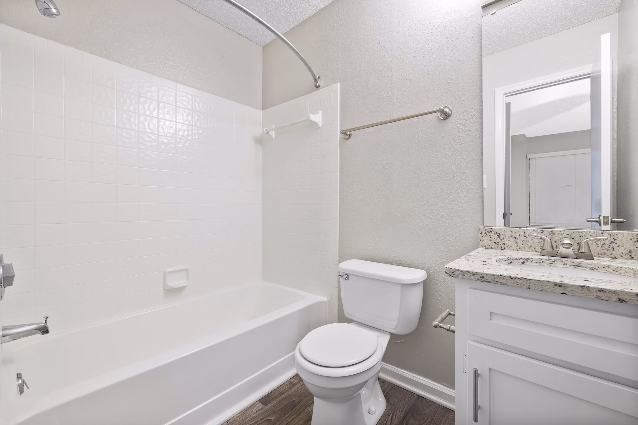 Modern bathroom with marble finishes and glass shower at Sailboat Bay Apartments