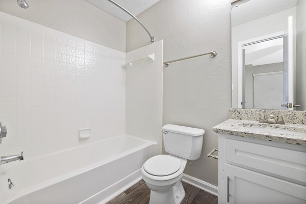 Modern bathroom with marble finishes and glass shower at Sailboat Bay Apartments