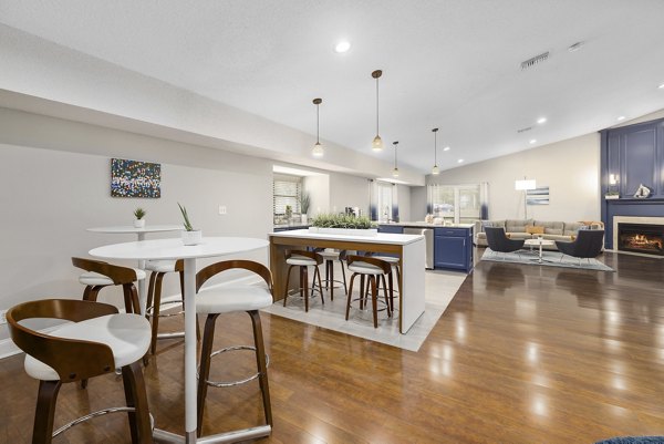 Modern clubhouse with lounge seating and pool table at Sailboat Bay Apartments