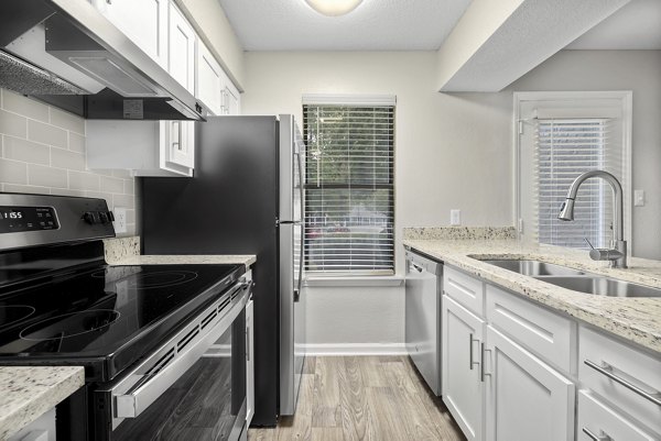 Fitness center equipped with cardio machines and free weights at Sailboat Bay Apartments