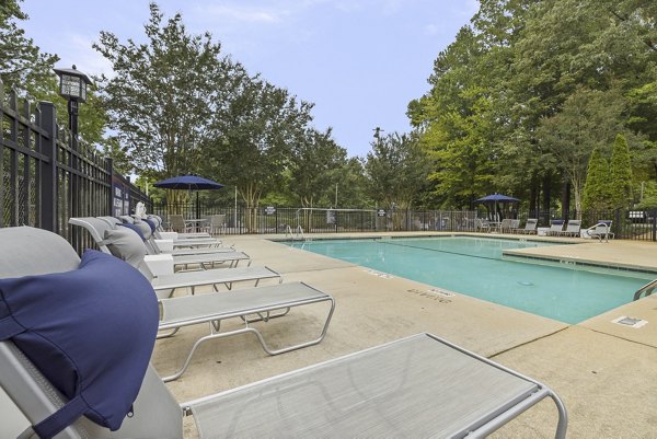 Resort-style swimming pool with lounge chairs at Sailboat Bay Apartments, luxury waterfront living