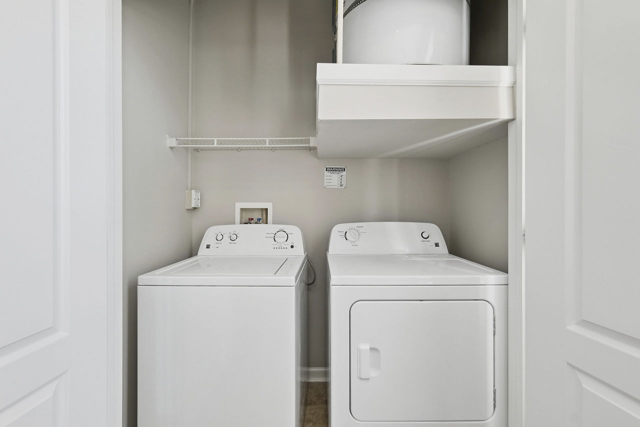 Laundry room at Central Square At Watermark Apartments
