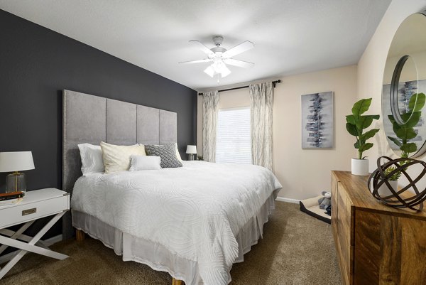 Cozy bedroom with modern furnishings at Encore at the Park Apartments in a luxury setting