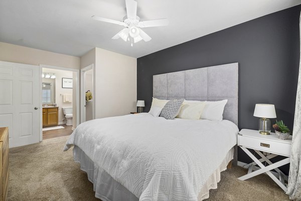 Cozy bedroom with modern furnishings at Encore at the Park Apartments