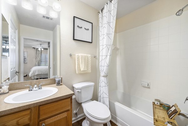 Luxurious bathroom with modern fixtures at Encore at the Park Apartments, featuring elegant design and spacious layout