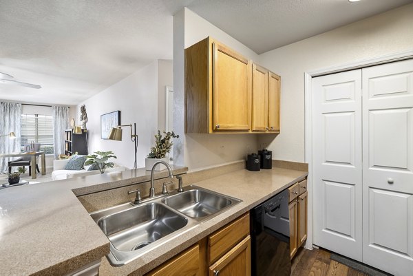 Modern kitchen with stainless steel appliances at Encore at the Park Apartments