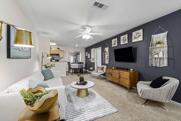Bright living room with modern furnishings at Encore at the Park Apartments