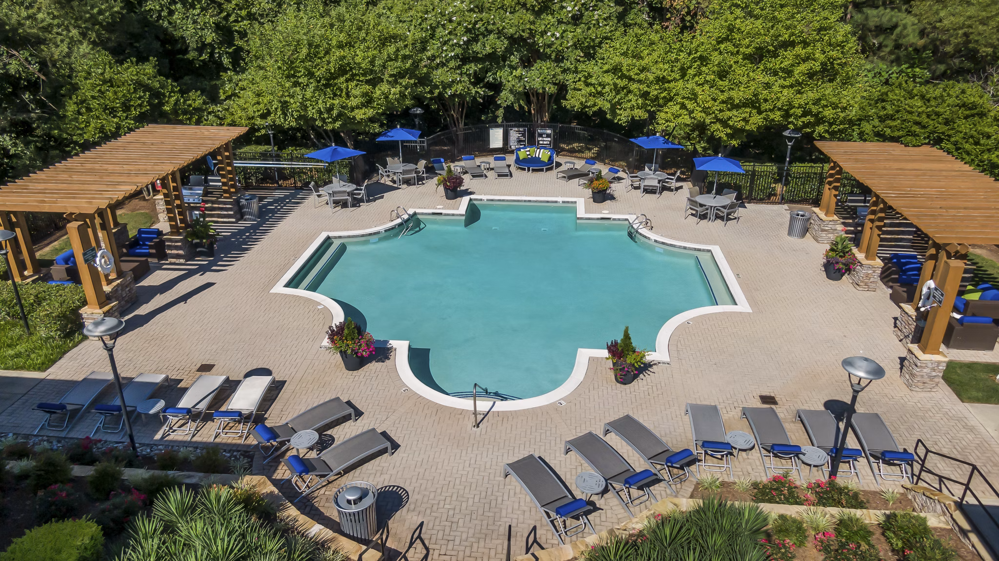 Luxury pool with private cabanas and lush landscaping at Encore at the Park Apartments, perfect for relaxation and entertainment