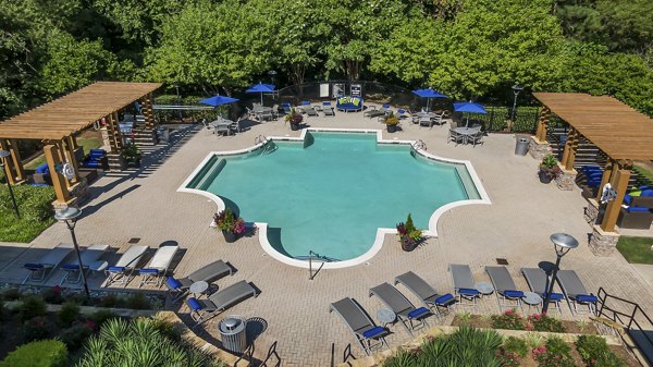 Luxury pool with private cabanas and lush landscaping at Encore at the Park Apartments, perfect for relaxation and entertainment