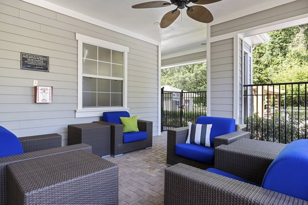 Chic outdoor patio with modern seating at Encore at the Park Apartments, perfect for relaxing and socializing in a luxury setting