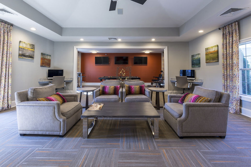 Clubhouse with modern seating and decor at Morgan Reserve Apartments, luxury living community by Greystar